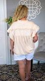 Sleeveless Ruffled Summer Blouse 6/18 - Fate & Co. We love to keep it boho and breezy for those hot summer days with this sleeveless blouse. The ruffles on the yoke and sleeves provide a soft, flirty and boho vibe, while the extended button down closure means that you can show off one of your new bralettes you have been wanting to wear! Date night, brunch, or happy hour, this cool-crisp shirt is sure to make heads turn where ever you go.  Color: Beige
